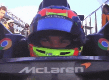 a man wearing a jack daniels helmet is sitting in a mclaren car