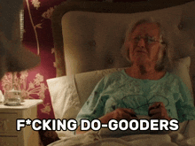 an elderly woman is laying in bed with the words " fucking do-gooders " on the bottom
