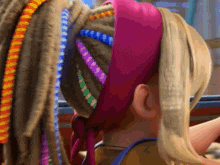 a close up of a woman 's hair with a pink headband