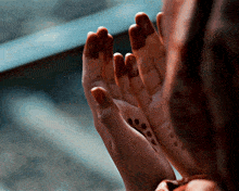 a close up of a person 's hands with henna on the fingers