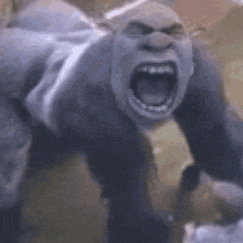 a gorilla is screaming with its mouth wide open in a blurry photo .