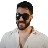 a man with a beard wearing sunglasses and a white shirt is smiling