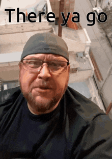 a man wearing glasses and a hat with the words there ya go on it