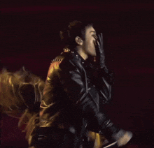 a man in a leather jacket is licking his lips