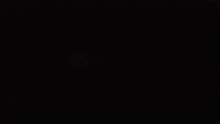a person 's face is visible in the dark
