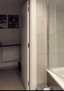 a bathroom with a bathtub and a painting on the wall