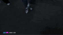 a blurry picture of a crowd of people walking down a hallway .