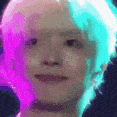 a close up of a person 's face with a purple and green background