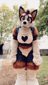 a furry fox mascot with a heart on his chest