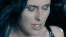a close up of a woman 's face with her eyes closed and her mouth open