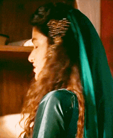 a woman wearing a green dress and a green veil on her head