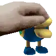 a hand is petting a stuffed animal with blue pants and blue boots .