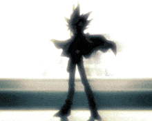 a silhouette of a person standing in a dark room