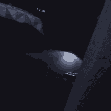 a light is shining in the dark and the time reads 12 pm