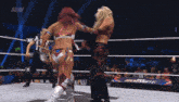 a woman is laying on the ground in a wrestling ring with aew written on the bottom