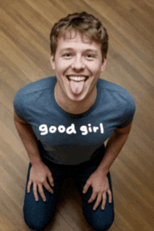 a man with his tongue out wearing a shirt that says good girl