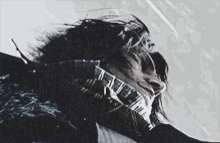 a close up of a person 's face with a scarf around it