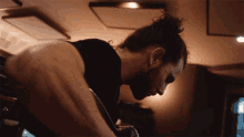 a man with long hair and a beard is playing a guitar