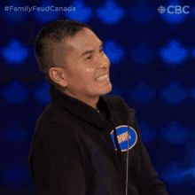 a man wearing a black sweatshirt with a blue circle that says owen
