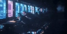 a blurry picture of a group of people sitting in front of a computer screen .