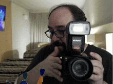 a man taking a picture with a camera that says yooba on it