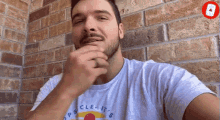 a man with a beard is wearing a shirt that says dope clean it 's on it
