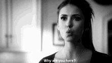 a black and white photo of a woman making a funny face and saying `` why are you here '' .