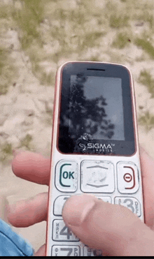 a person is holding a sigma cellphone in their hand