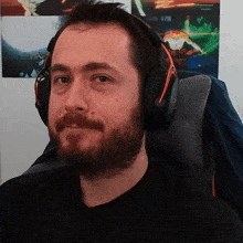 a man with a beard is wearing headphones and a black shirt