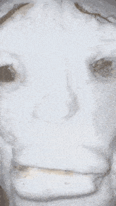 a close up of a snowman 's face with a sad expression