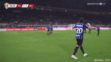 a soccer player with the number 20 on his jersey celebrates a goal