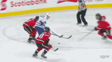 a hockey game is being played on a rink with an ad for draftkings in the background
