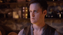 a man is talking and saying `` i will remember this '' in front of a blurred background .