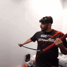 a man wearing a shirt that says ' stcplay power ' on it