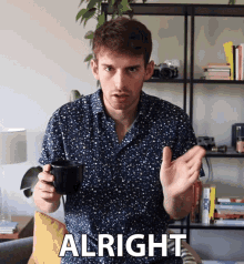 a man in a blue shirt is holding a cup of coffee and saying " alright "