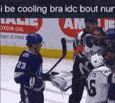 a hockey player wearing number 23 talks to another player