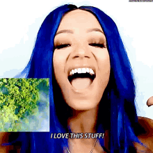 a woman with blue hair is smiling and saying i love this stuff