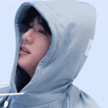 a close up of a person wearing a hooded sweatshirt