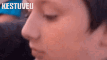 a close up of a person 's face with the words " kestuveu " on the bottom right