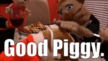 two puppets are sitting at a table with the words good piggy