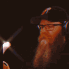 a man with a beard wearing headphones and glasses