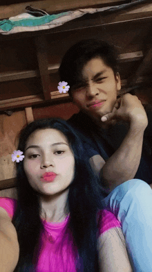 a boy and a girl are posing for a picture