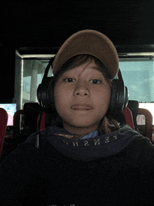 a person wearing headphones and a hat with the letter n on the neck