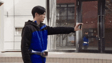 a man in a blue jacket is taking a picture