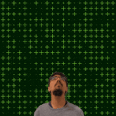 a man stands in front of a green background with the number 11