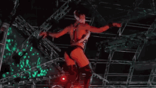 a woman is dancing on a stage in front of a crowd