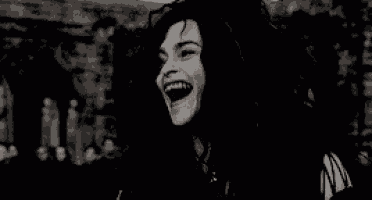 a black and white photo of a woman laughing with her mouth open .