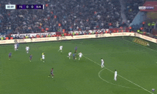 a soccer game is being played in front of a crowd and the score is 0-0