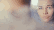 a close up of a woman 's face with a smoke coming out of her mouth .