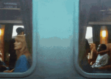a blurred image of people sitting on a bus with a sign that says ' a ' on it
